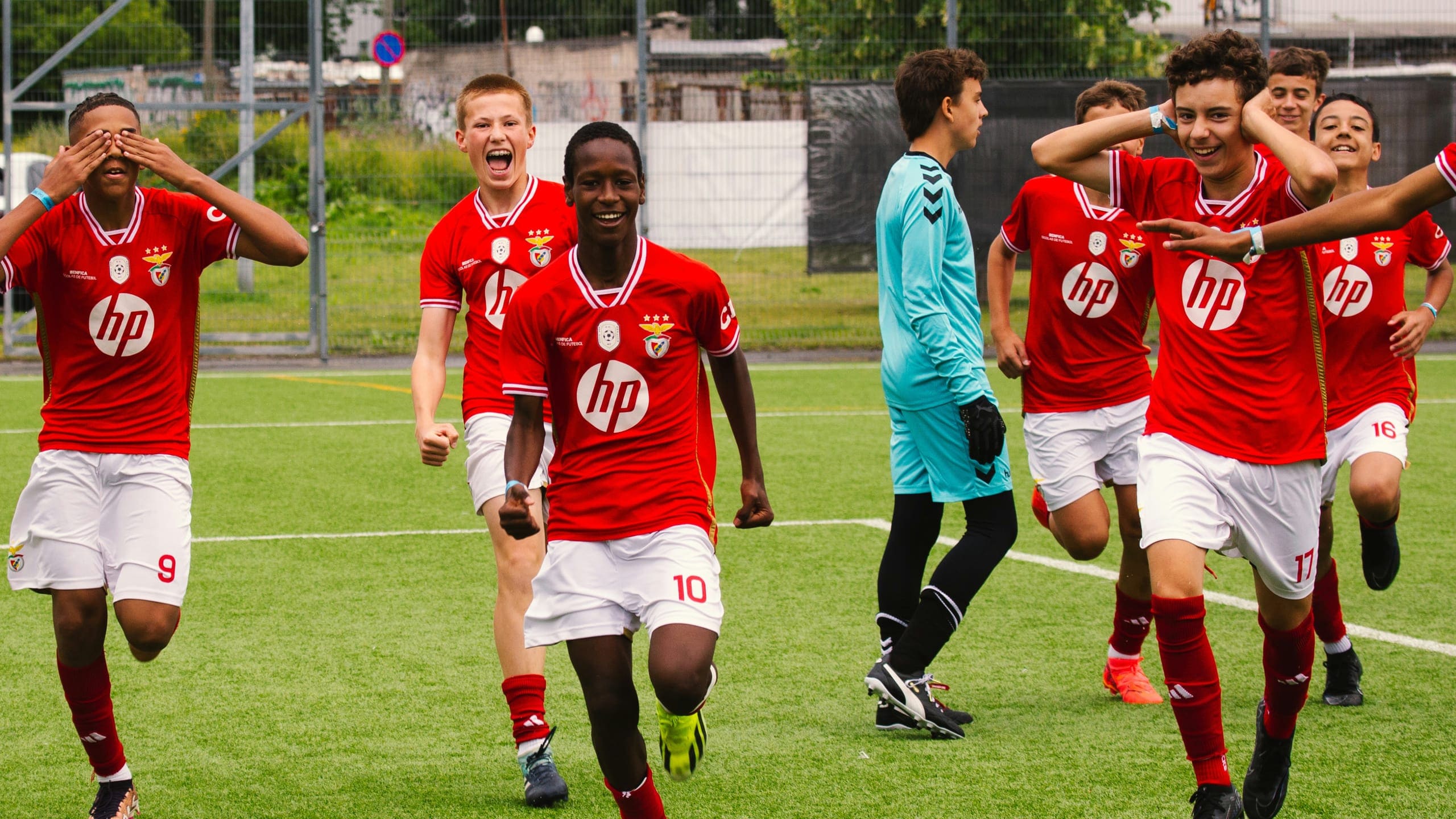 A team in red celebrating a goal at the Tallinn Cup